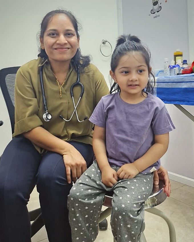 Dr. Megha Kadam with a young patient during a consultation at her RT Nagar clinic