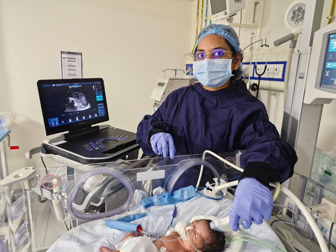 Dr. Megha Kadam assessing a baby at the bedside